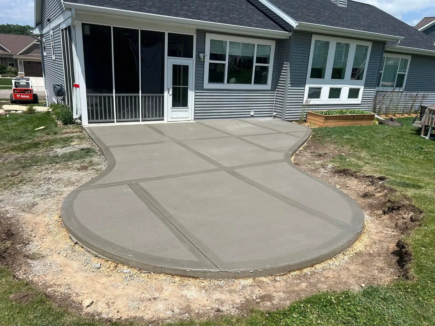 Broom-finish concrete patio with a long radius edge